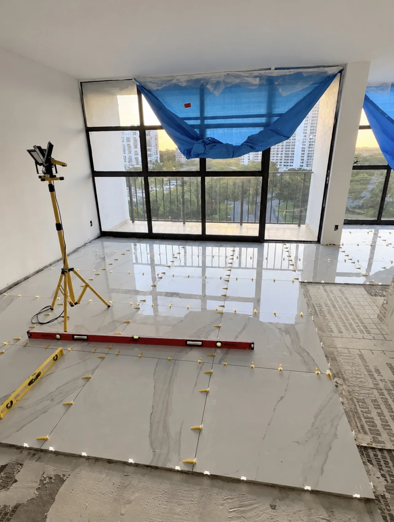 Floor tile installation with leveling spacers