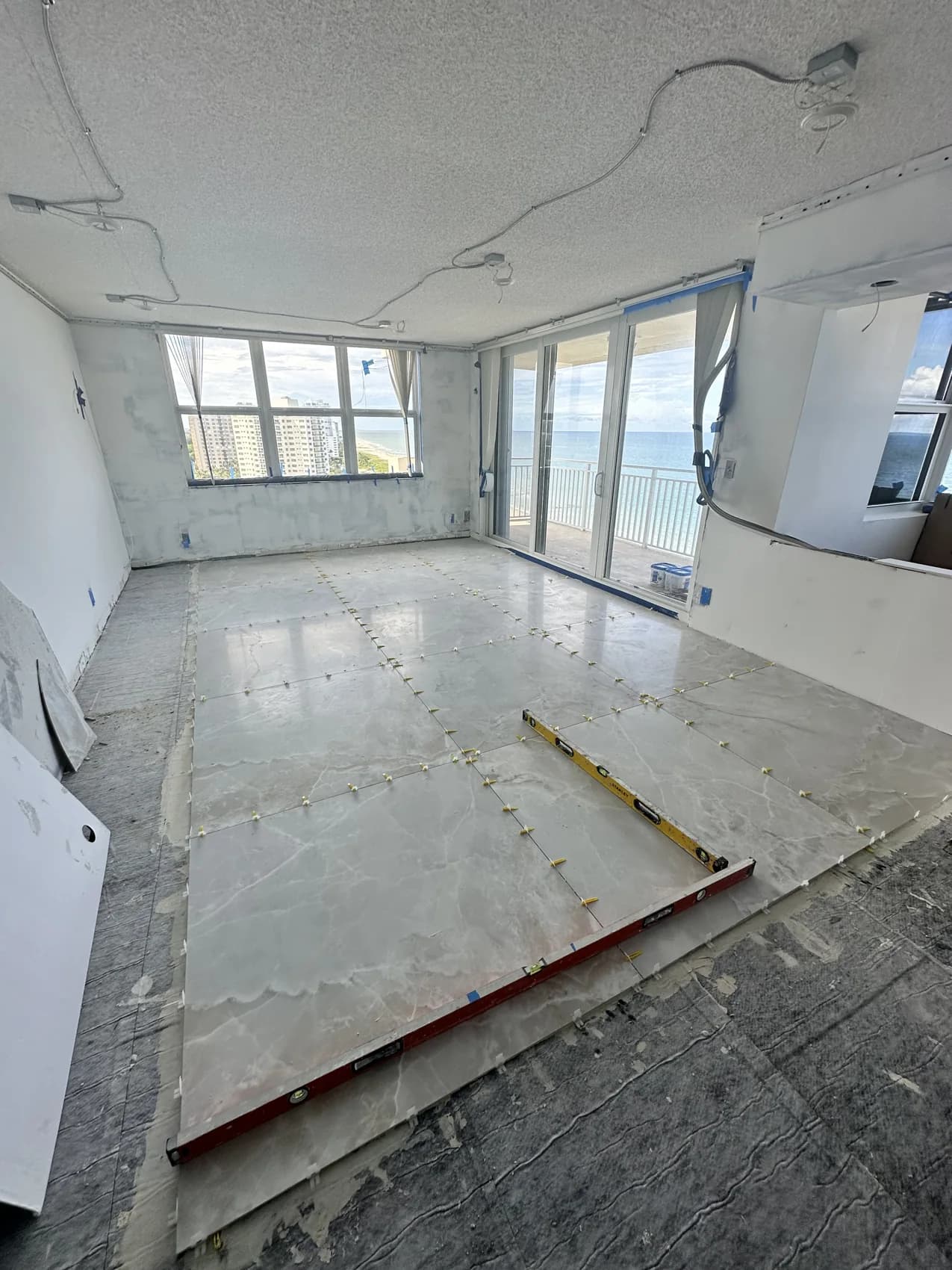Large-format tile floor installation in progress