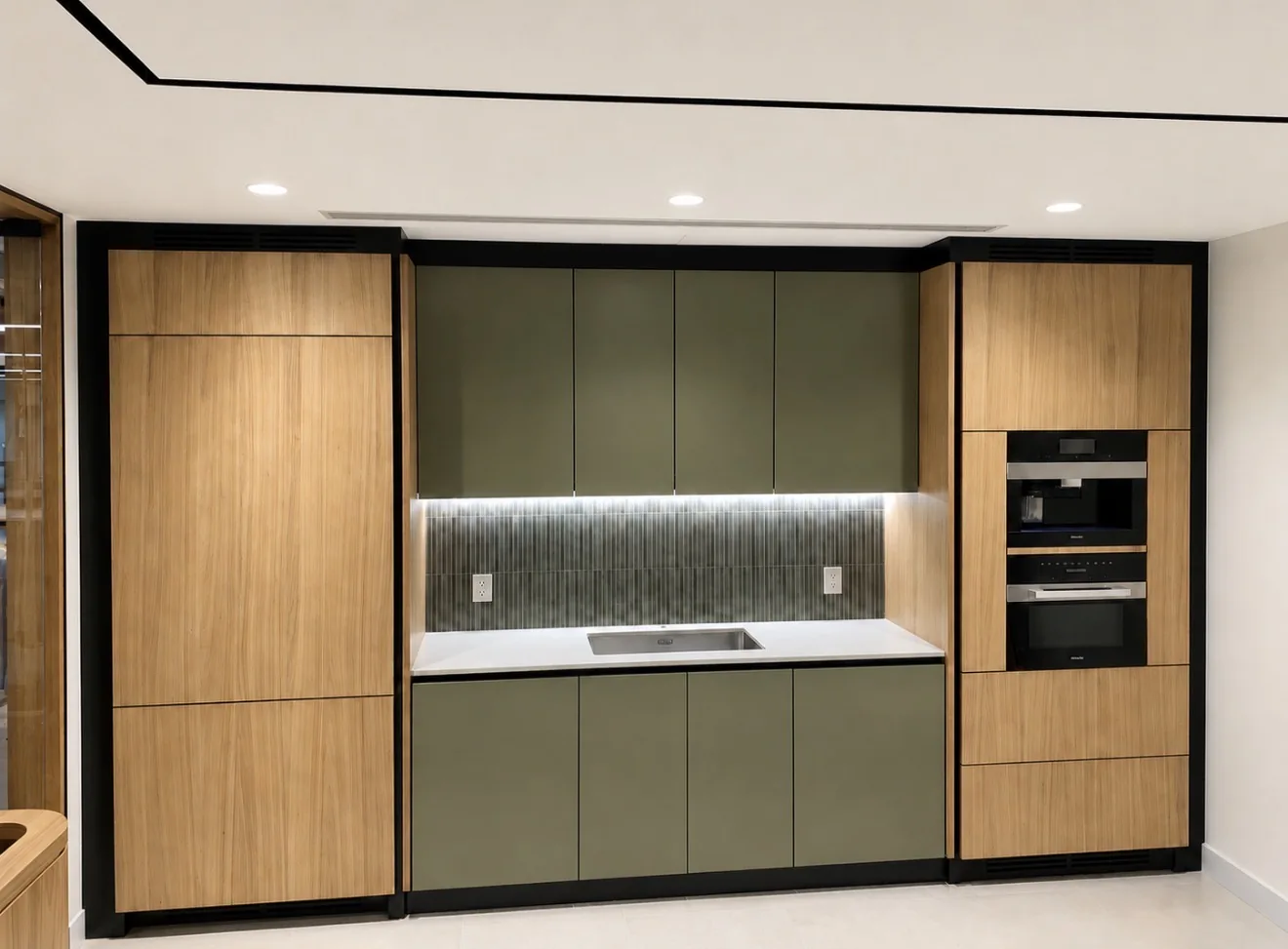 Wood and muted green cabinetry with integrated appliances and under-cabinet lighting.